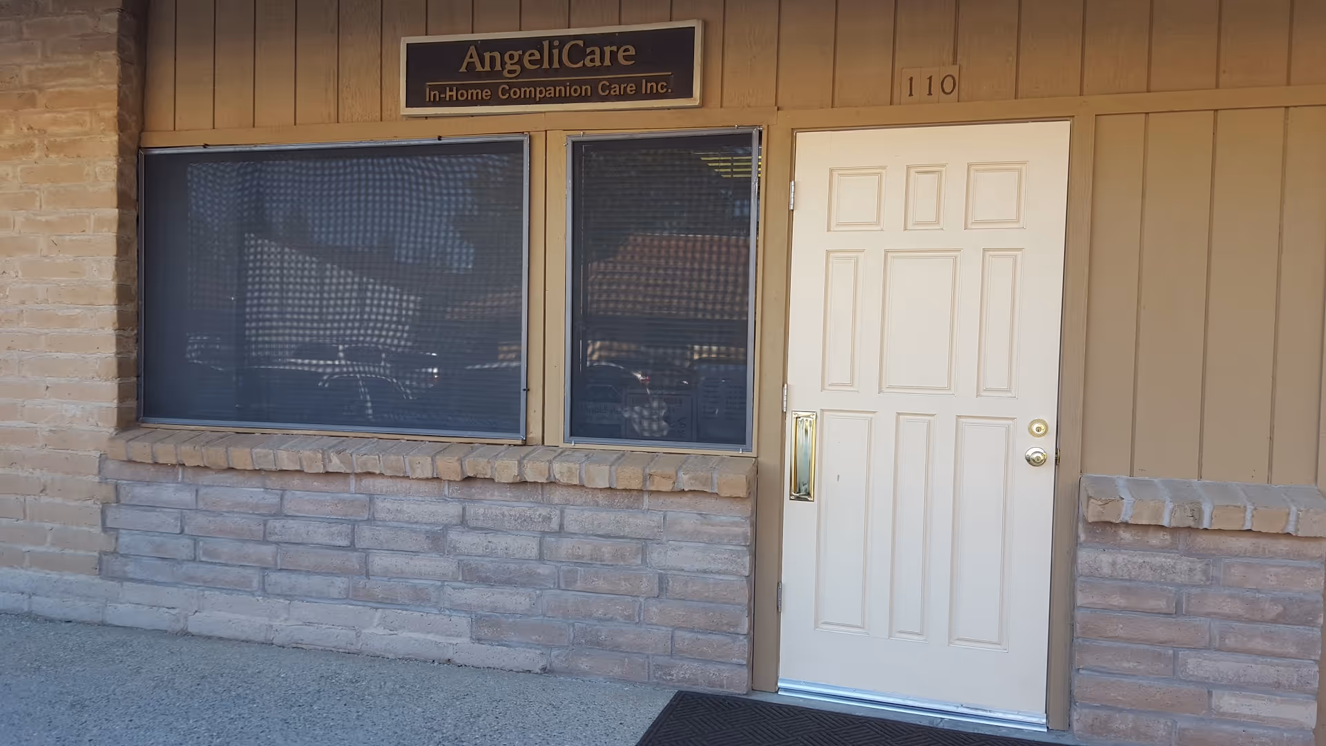 Exterior view of Angelicare In-Home Companion Care entrance with a white door and windows.