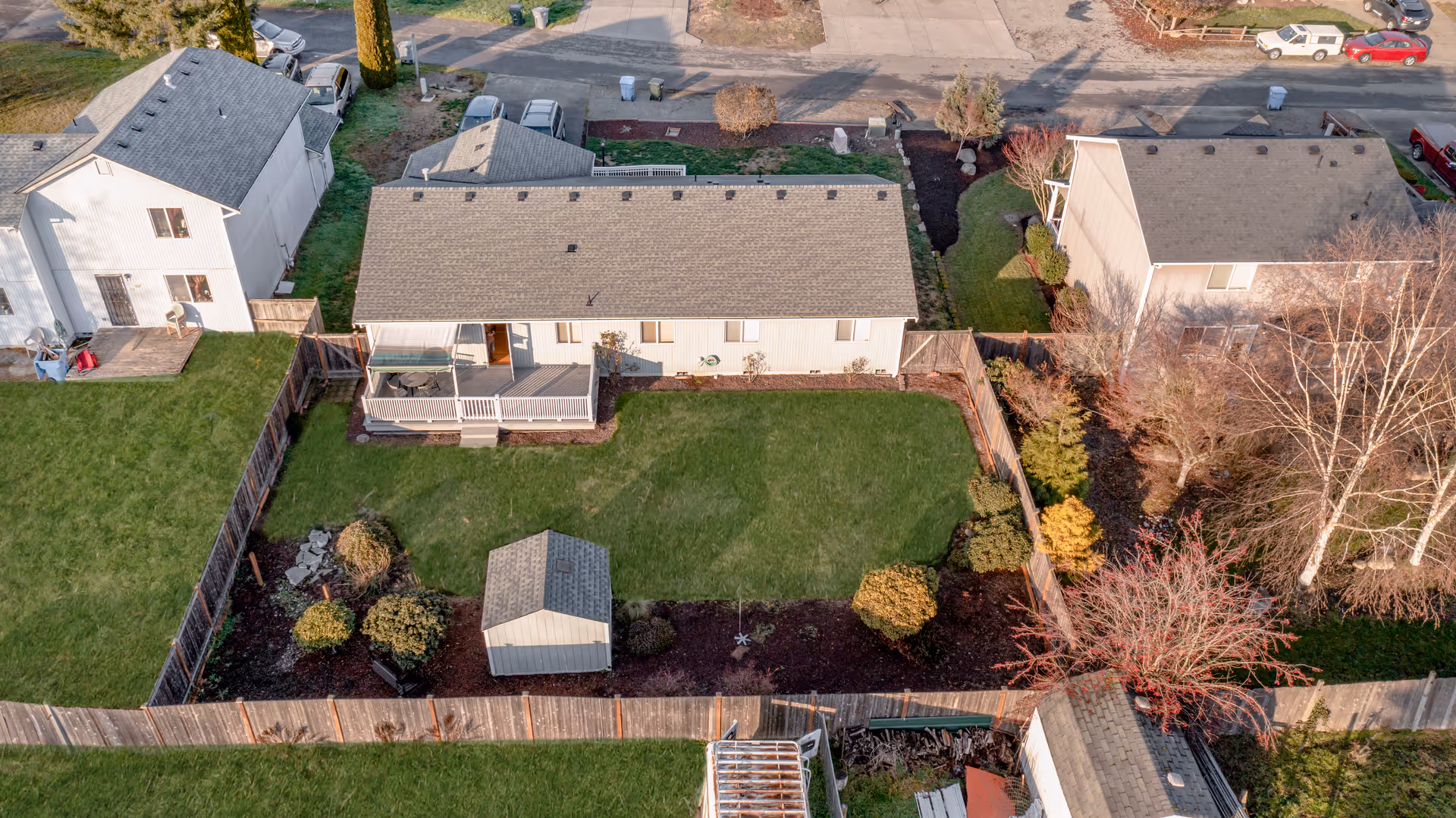 Aerial view of Clover Care Adult Family Home showing fenced yard and back deck.