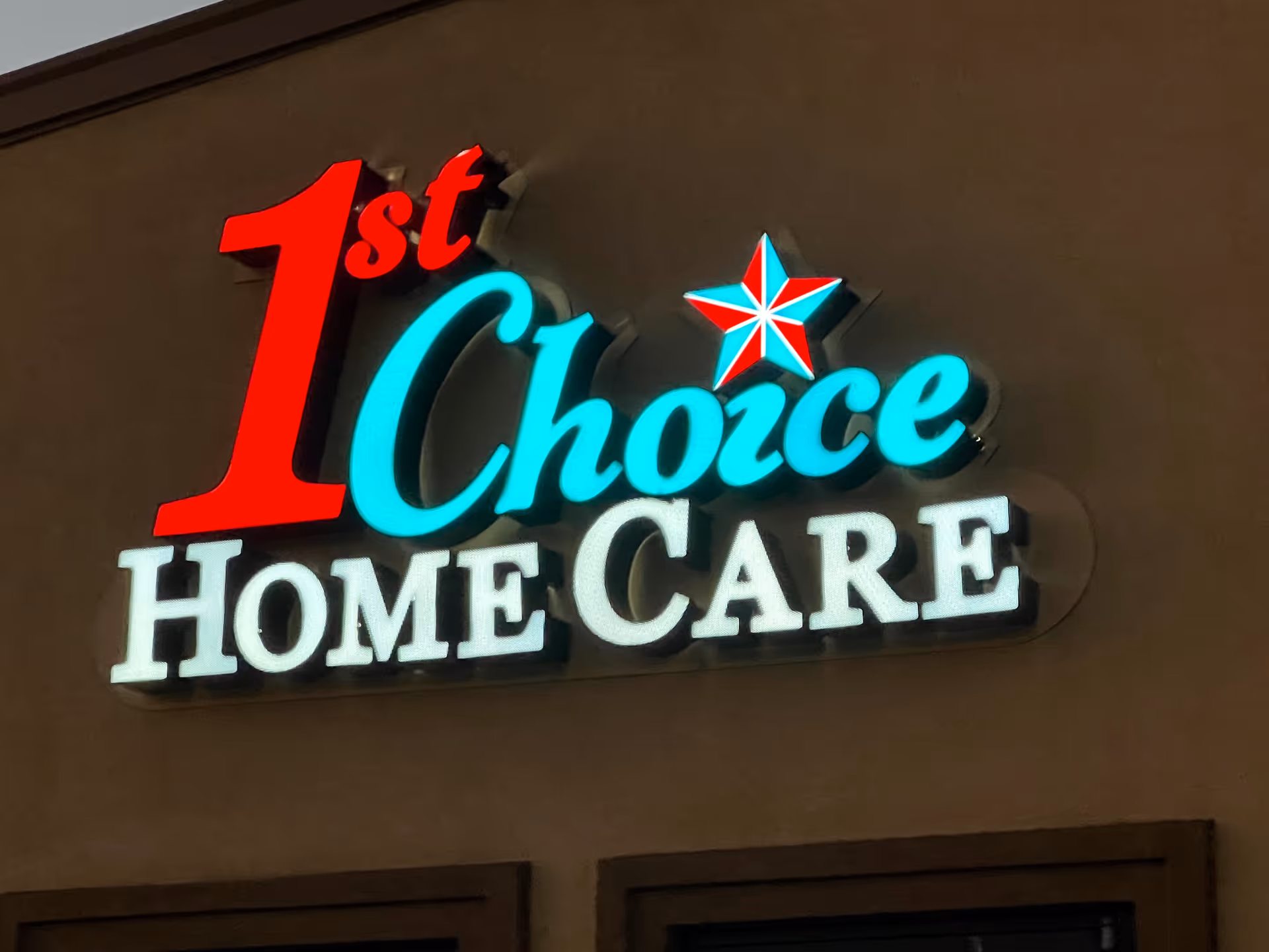 Exterior view of a building with a neon sign reading '1st Choice Home Care'.