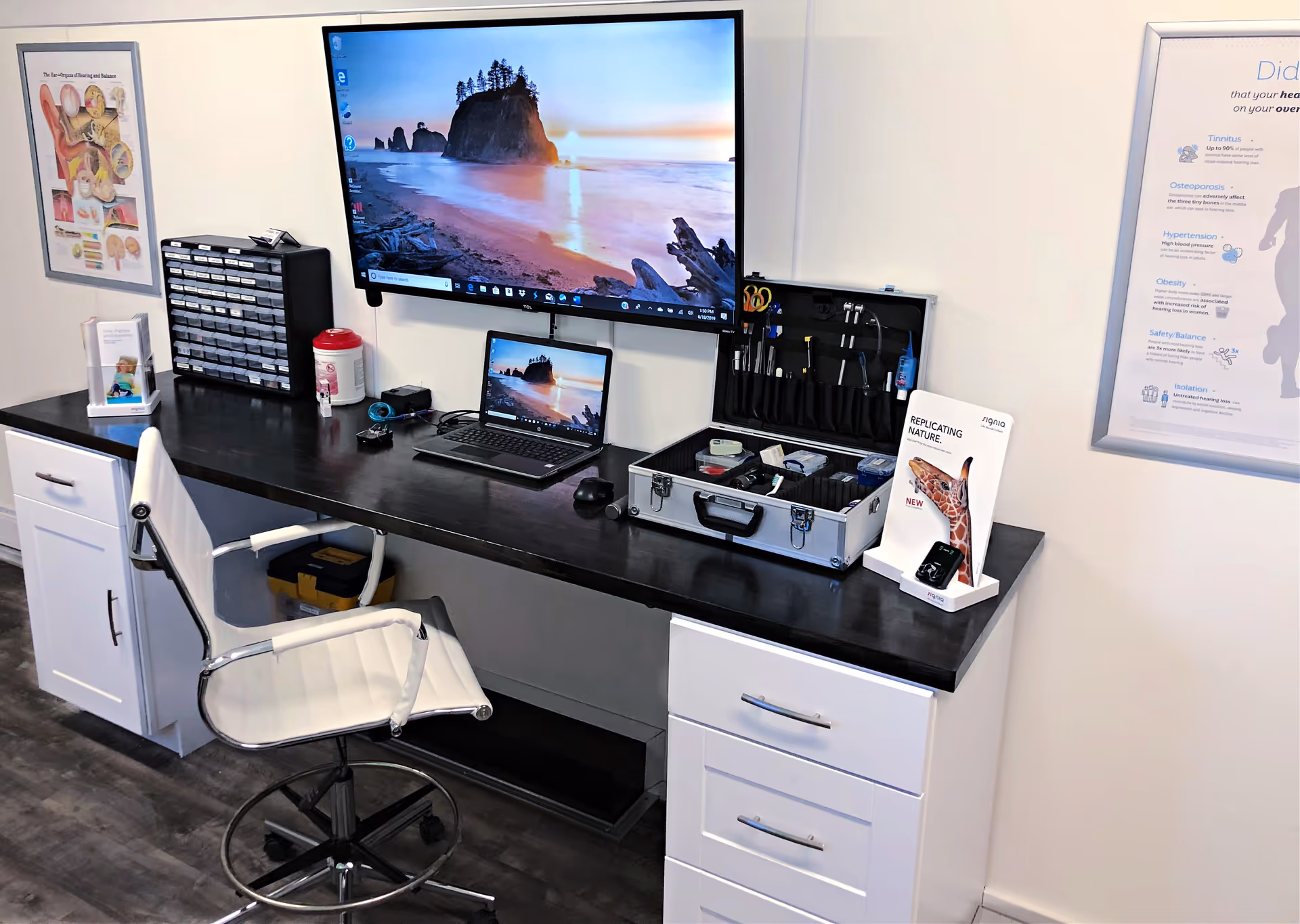 Dove Hearing Center interior with a desk, computer, and medical tool kit.