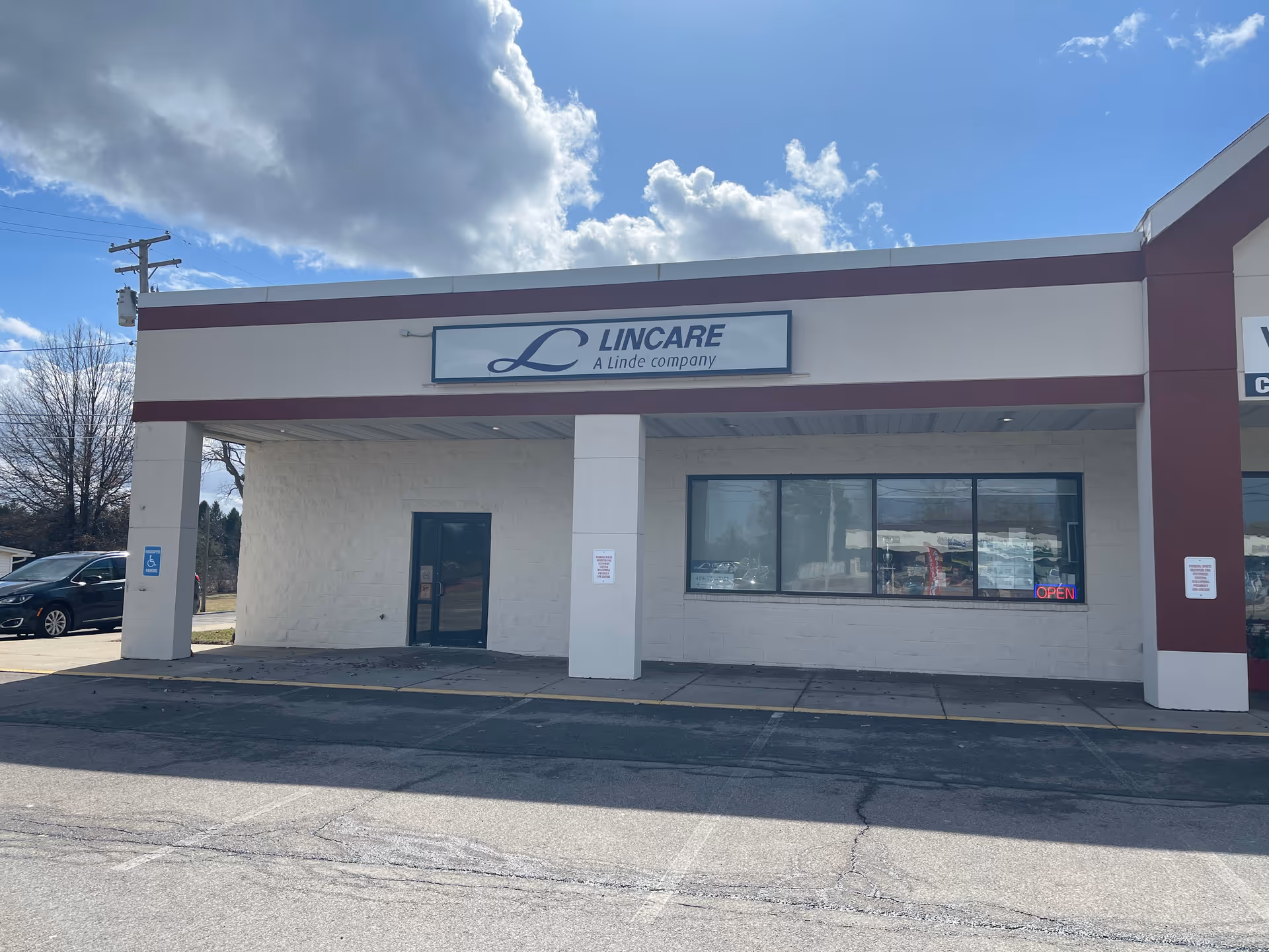 Exterior of LINCARE storefront with sign, large window, and single entrance.