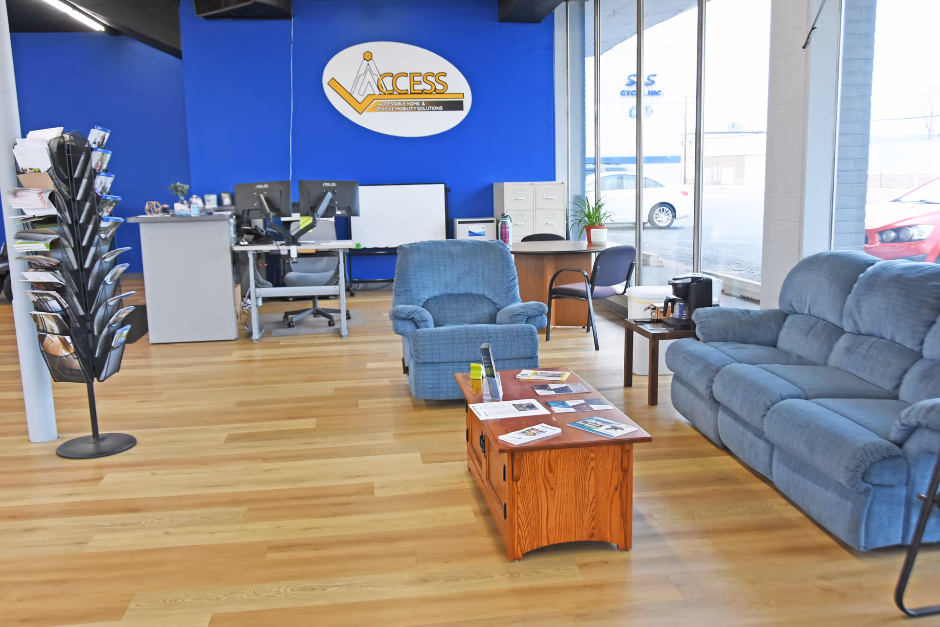 Lobby area with blue seating, desks, and an Access Elevator sign on a blue wall.