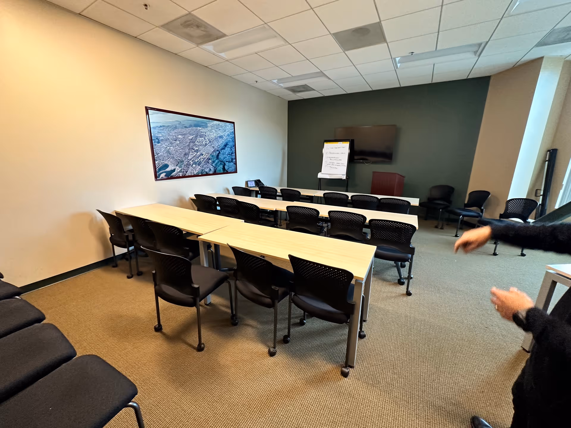 Classroom-style meeting room in a senior facility with tables and chairs.