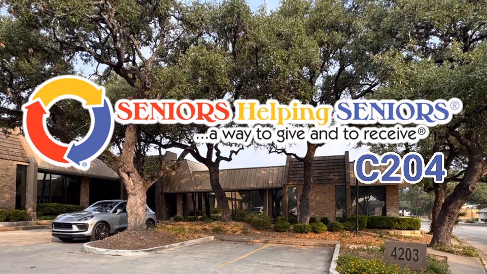 Exterior view of Seniors Helping Seniors facility with logo, trees, and parking lot