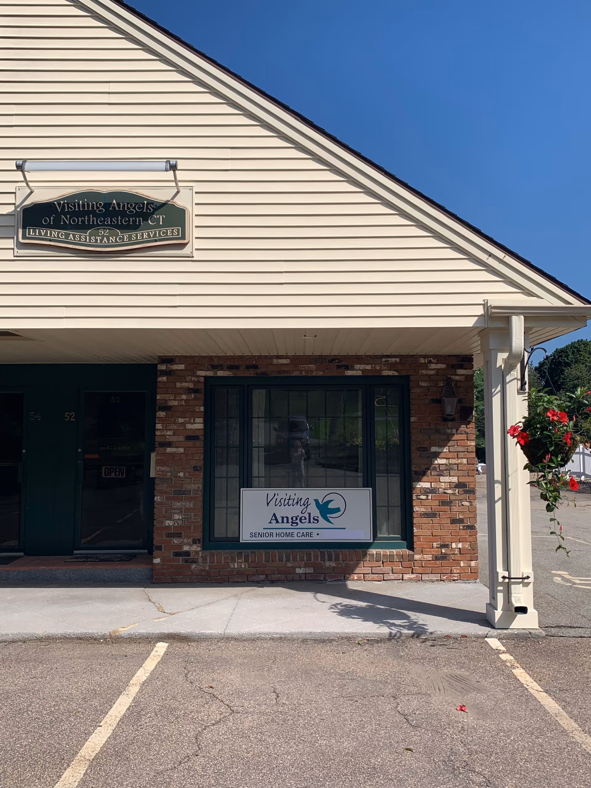 Exterior view of Visiting Angels storefront with sign and brick facade