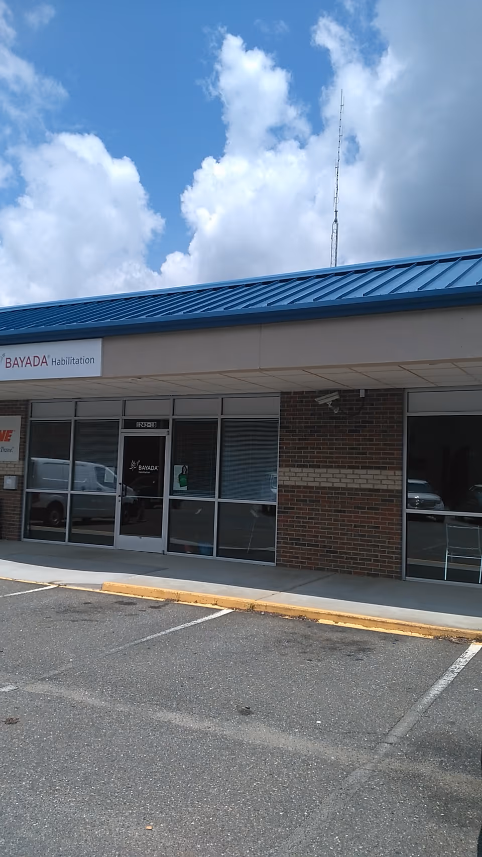 Exterior view of BAYADA Habilitation facility with glass entry and parking lot