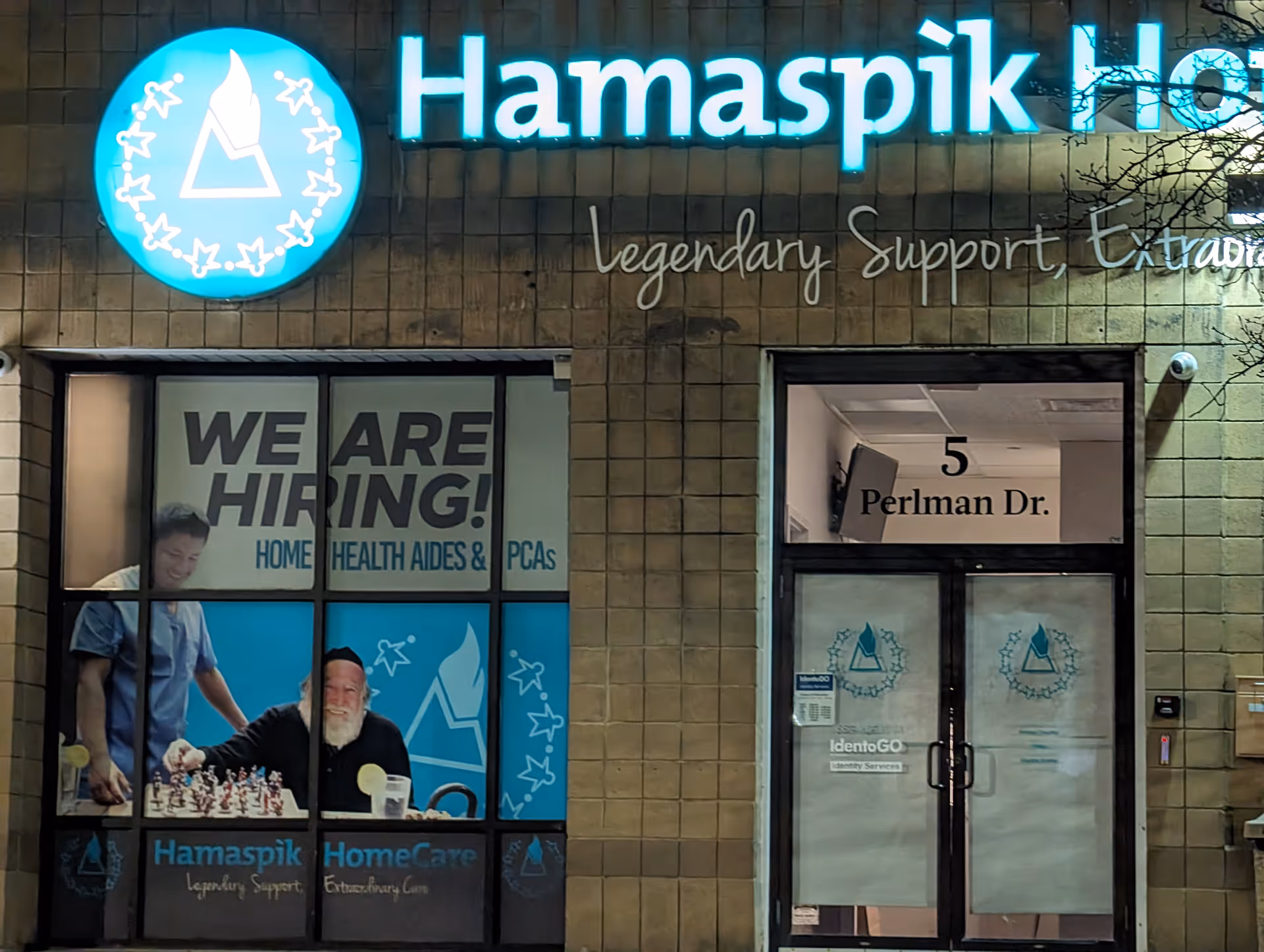 Exterior view of Hamaspik HomeCare facility with a WE ARE HIRING window display