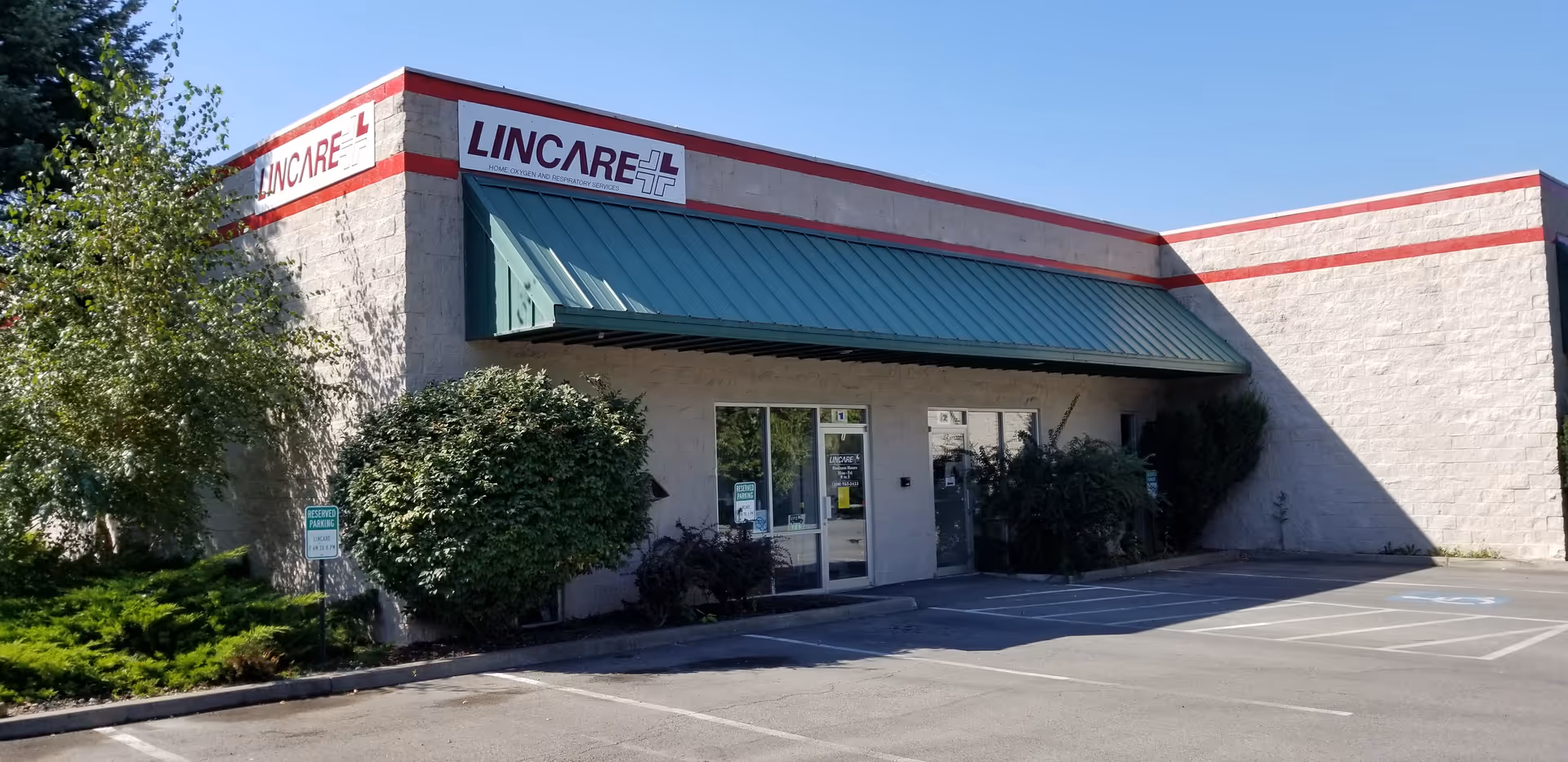 Exterior view of a LINCARE building with entrance and a green awning.